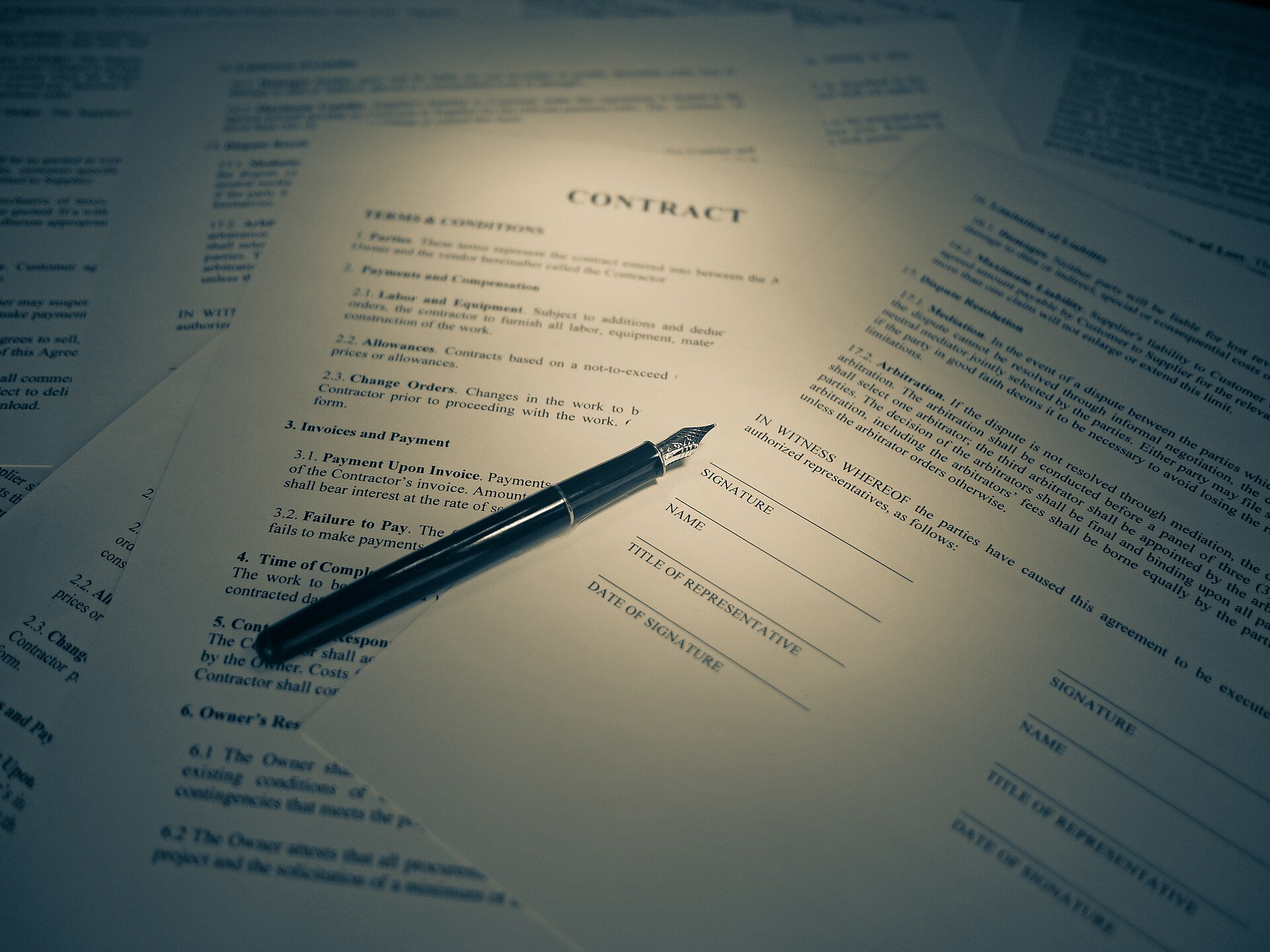 freelance contract basics: a printed contract and pen ready for a signature