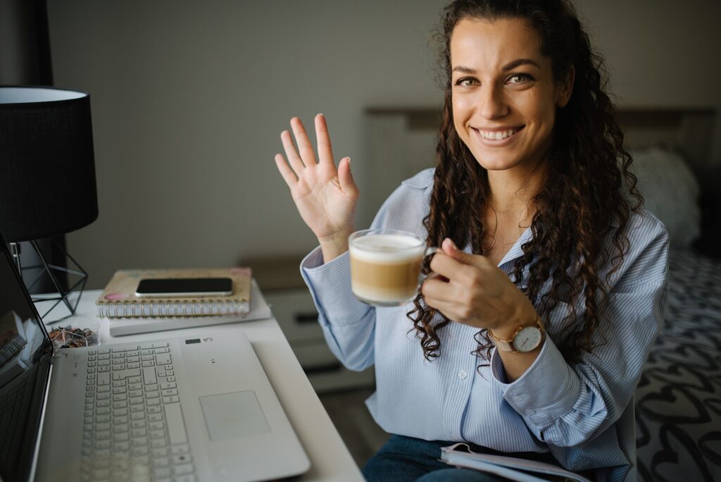 freelance retainer agreement: a freelancer reviewing contract terms at a laptop with coffee
