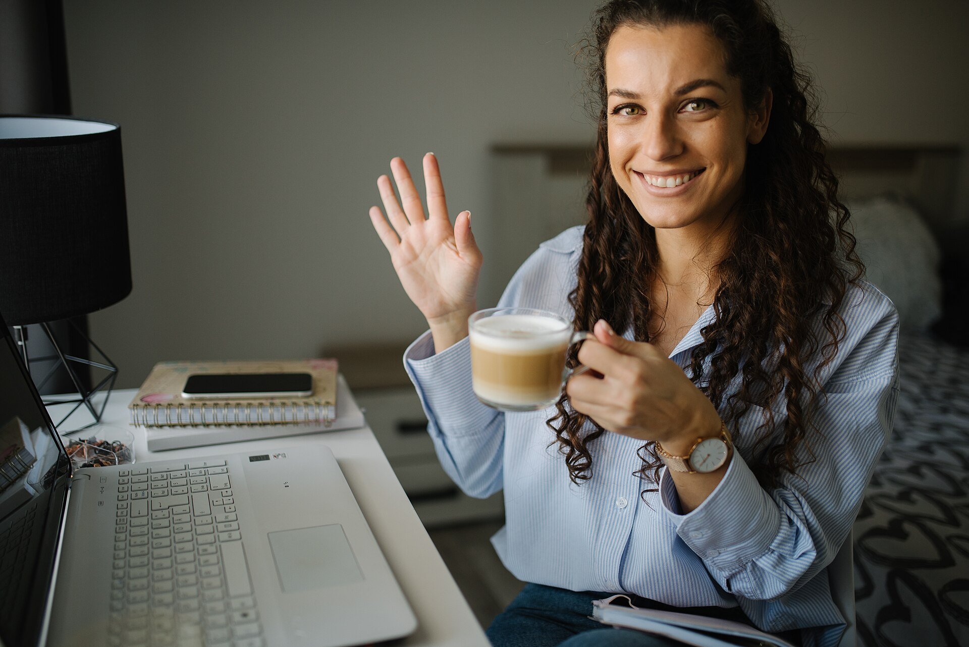 freelance retainer agreement: a freelancer reviewing contract terms at a laptop with coffee