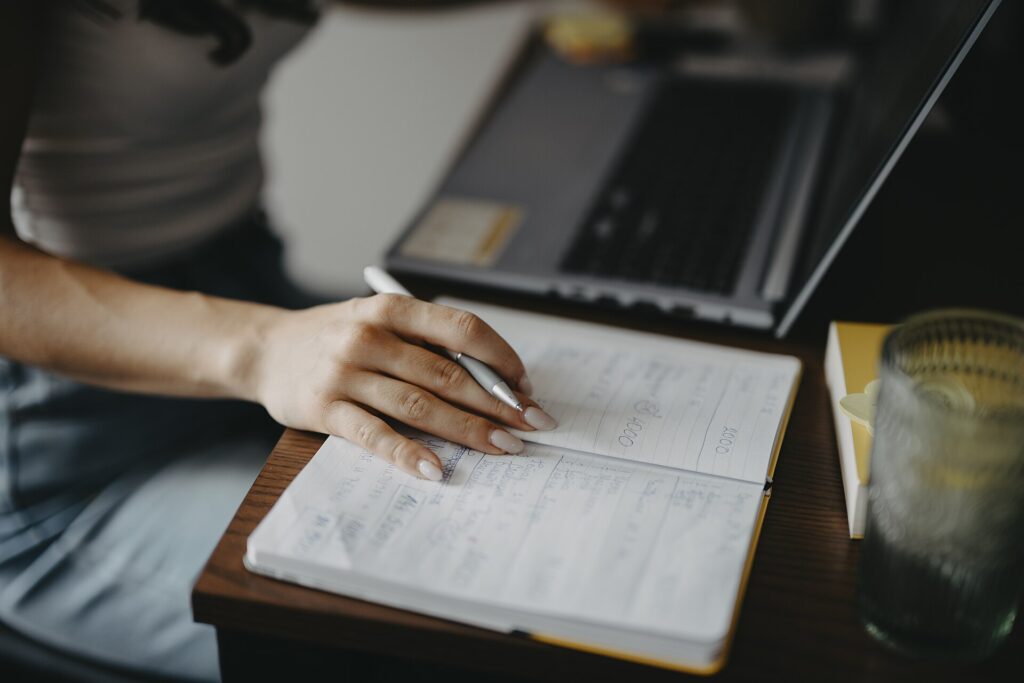 how to track freelance income: a freelancer logging payments at a desk